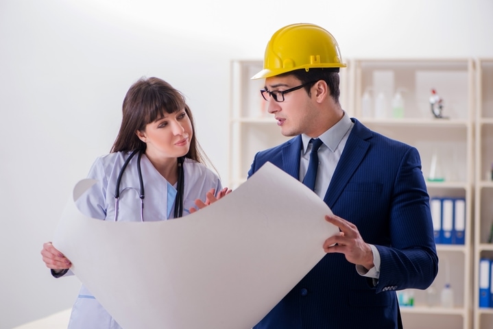 architect and doctor discussing about a blueprint