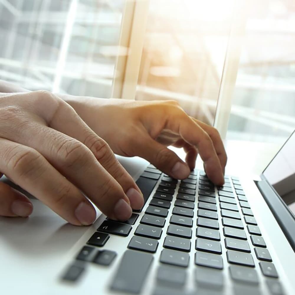 Double exposure of business man hand working on blank screen laptop computer on wooden desk as concept