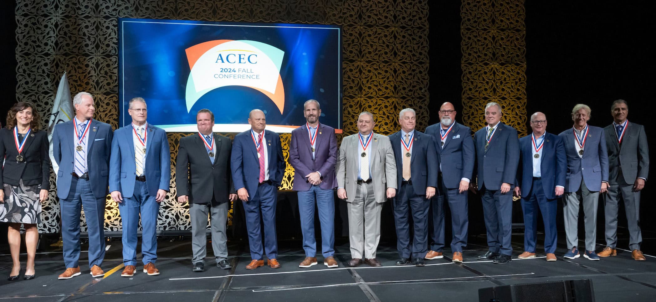 College of Fellows Inductees line up on stage