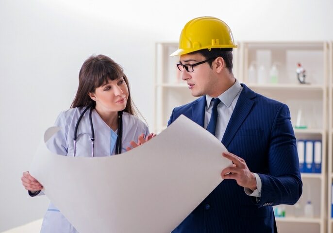 architect and doctor discussing about a blueprint