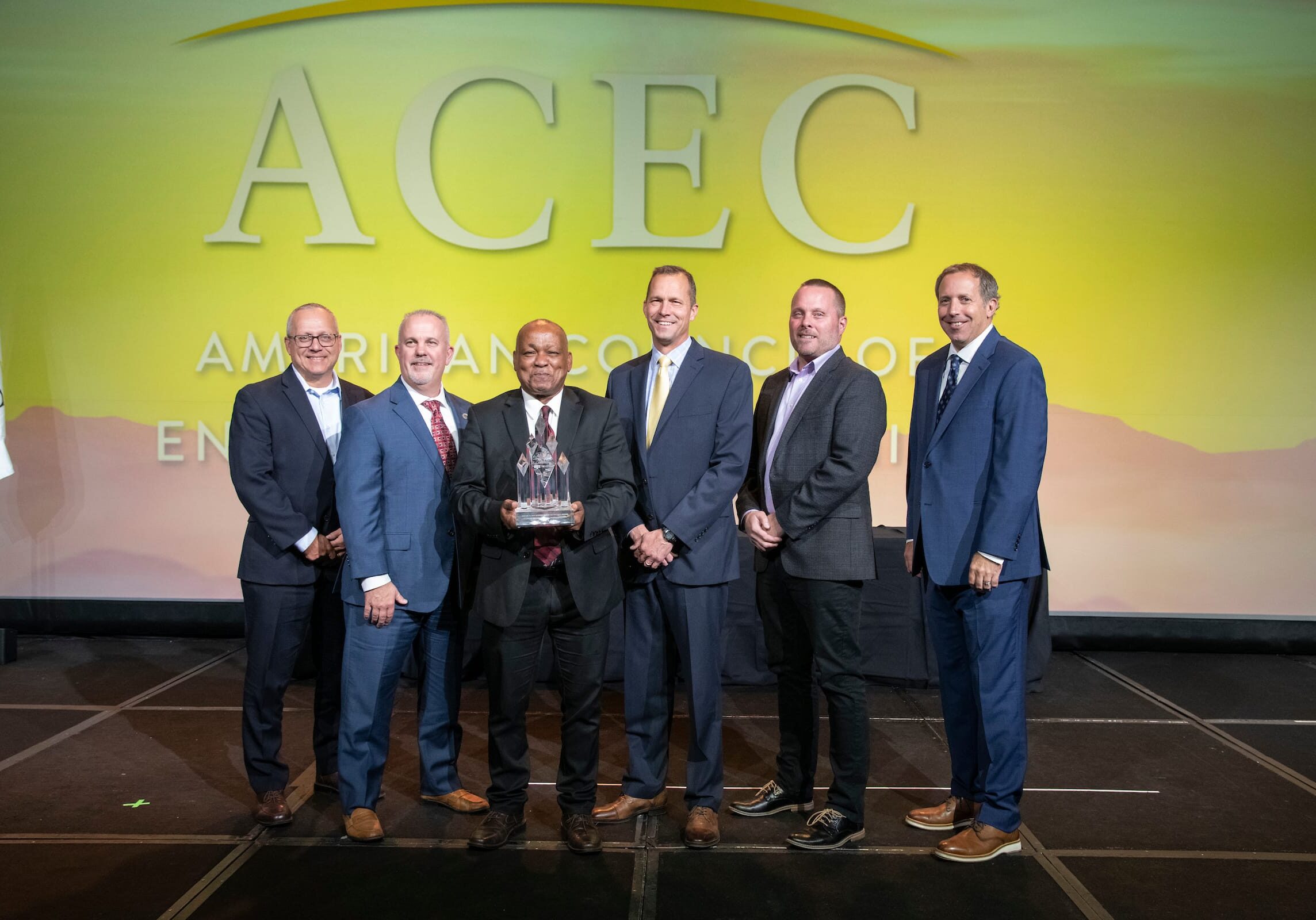 acec members standing on stage during awarding