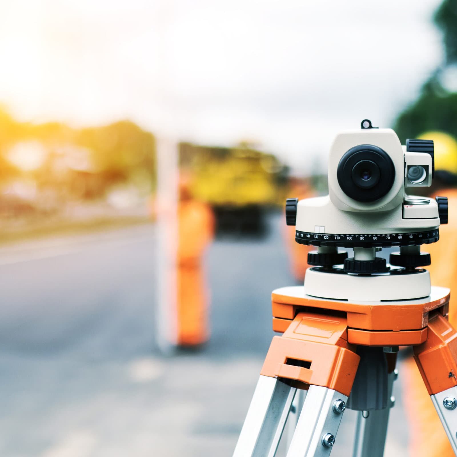 Surveyor’s telescope at new road construction site