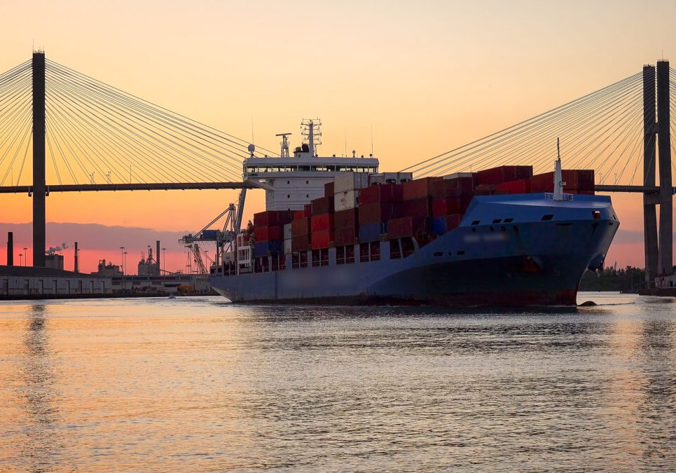 A commercial cargo ship as it leaves the Port of Savannah in Georgia at sunset