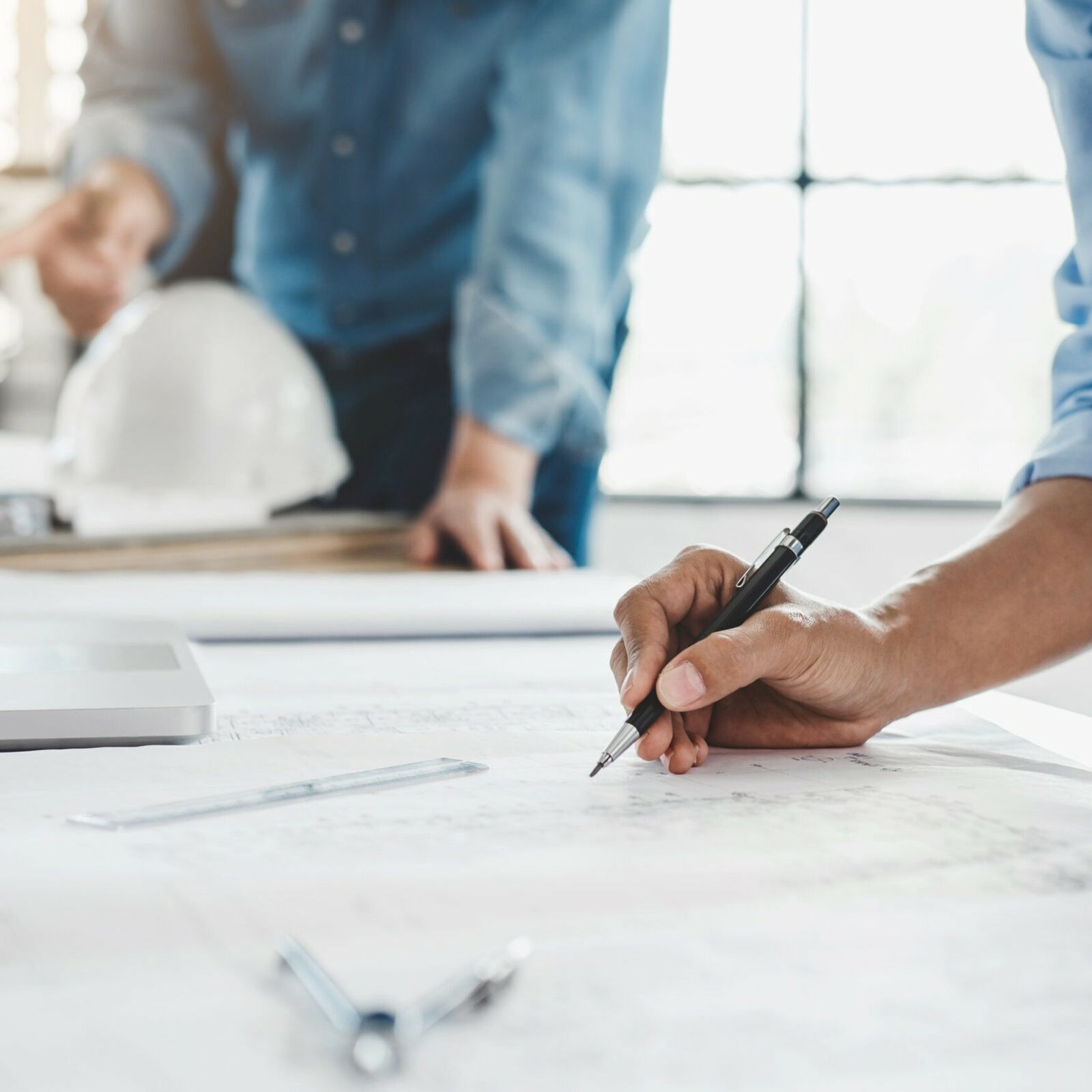 Hands of architect or engineer working on blueprint meeting for project working with partner on model building and engineering tools in working site, Construction concept.