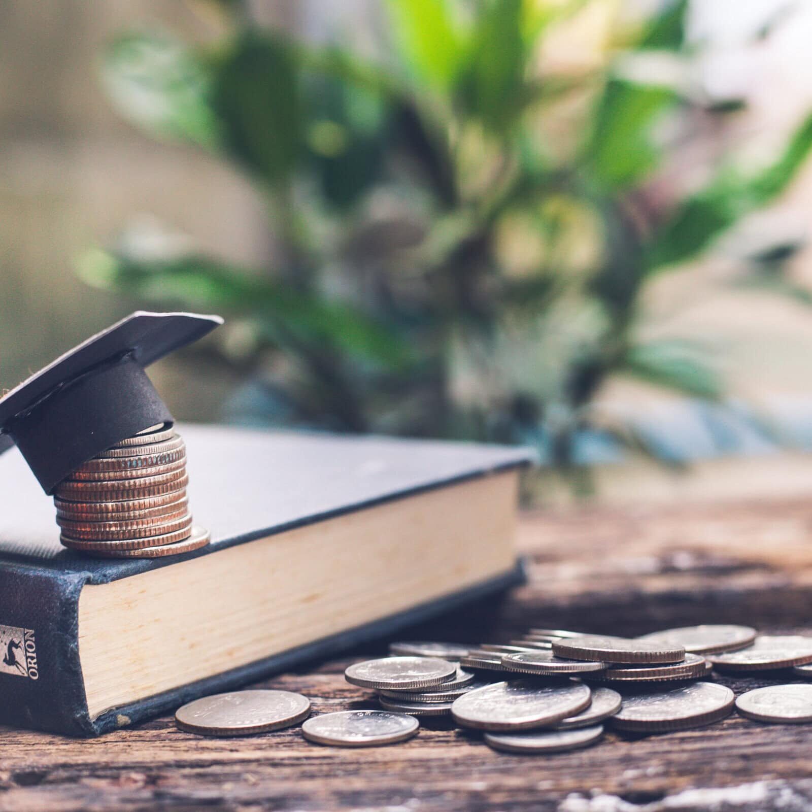 Saving money financial concept, congratulations graduates cap on
