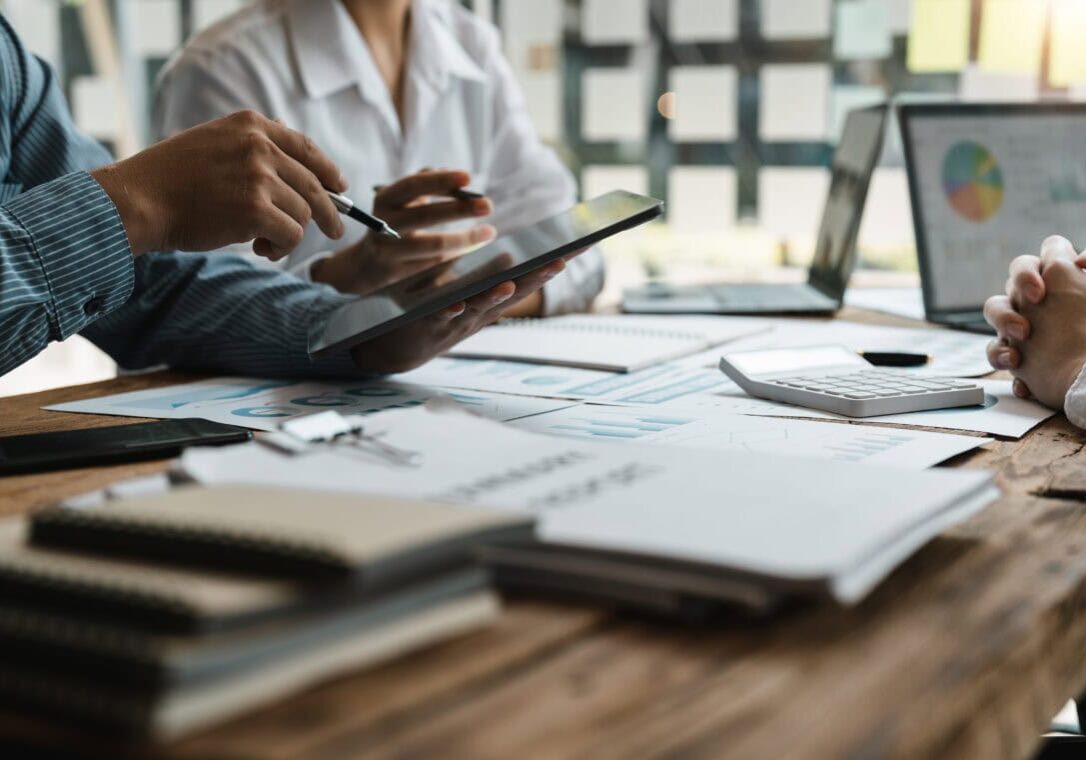 Asian business adviser meeting to analyze and discuss the situation on the financial report in the meeting room.Investment Consultant,Financial Consultant,Financial advisor and accounting concept.