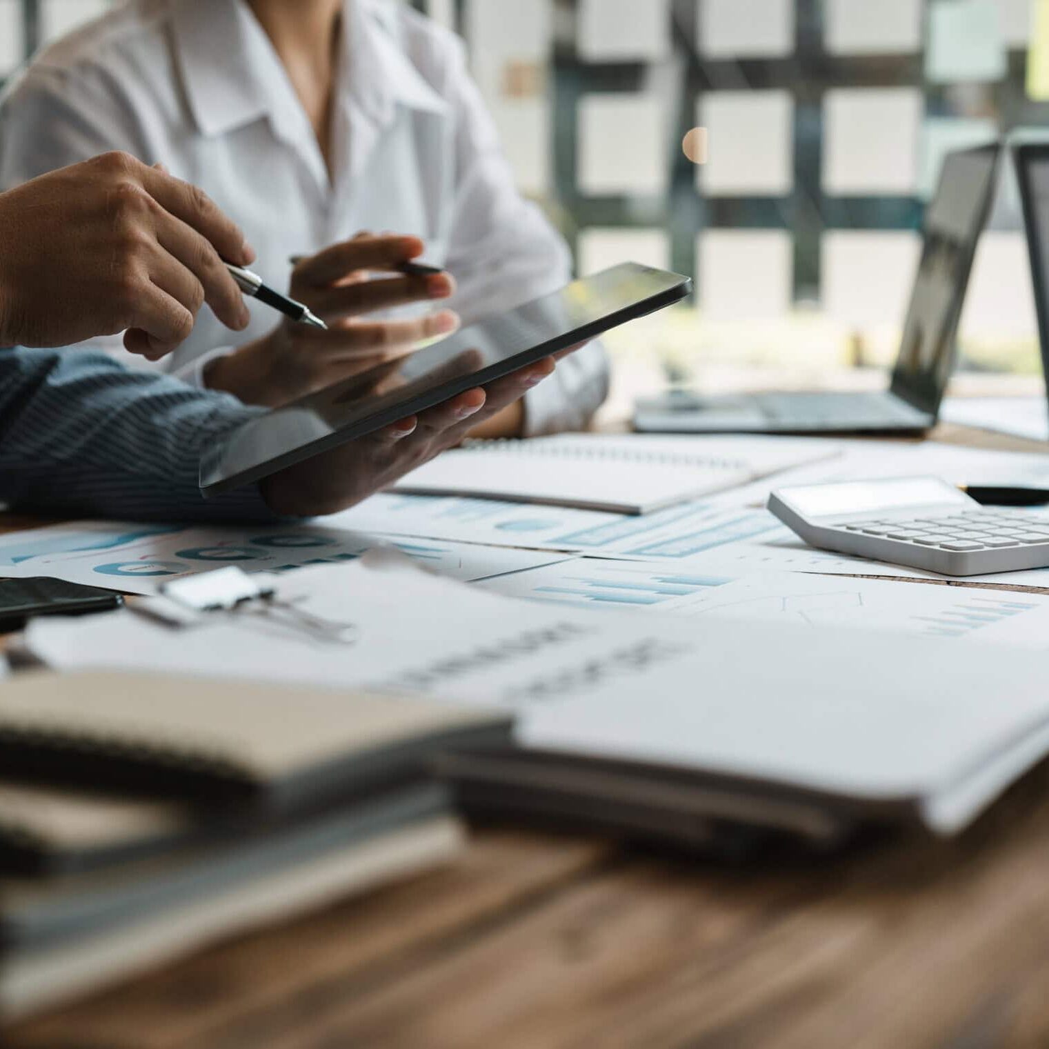 Asian business adviser meeting to analyze and discuss the situation on the financial report in the meeting room.Investment Consultant,Financial Consultant,Financial advisor and accounting concept.