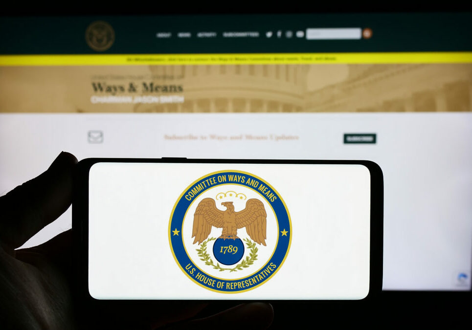 Stuttgart, Germany - 09-27-2023: Person holding smartphone with seal of United States House Committee on Ways and Means in front of website. Focus on phone display.