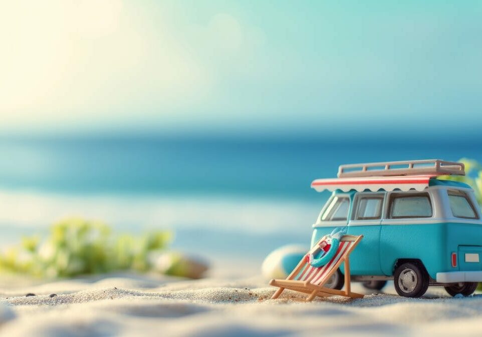 Small hippie blue minivan on the beach on a sunny summer day with a sunbathing chair. Summer holiday concept at sea or ocean