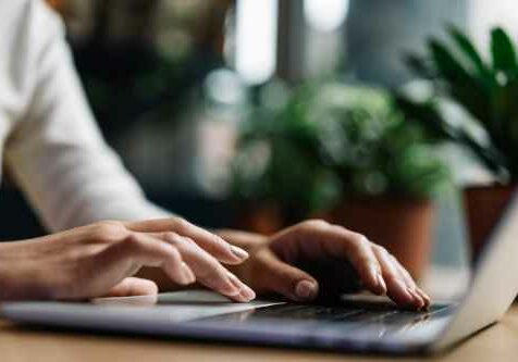 closeup photo of a hand while using a laptop