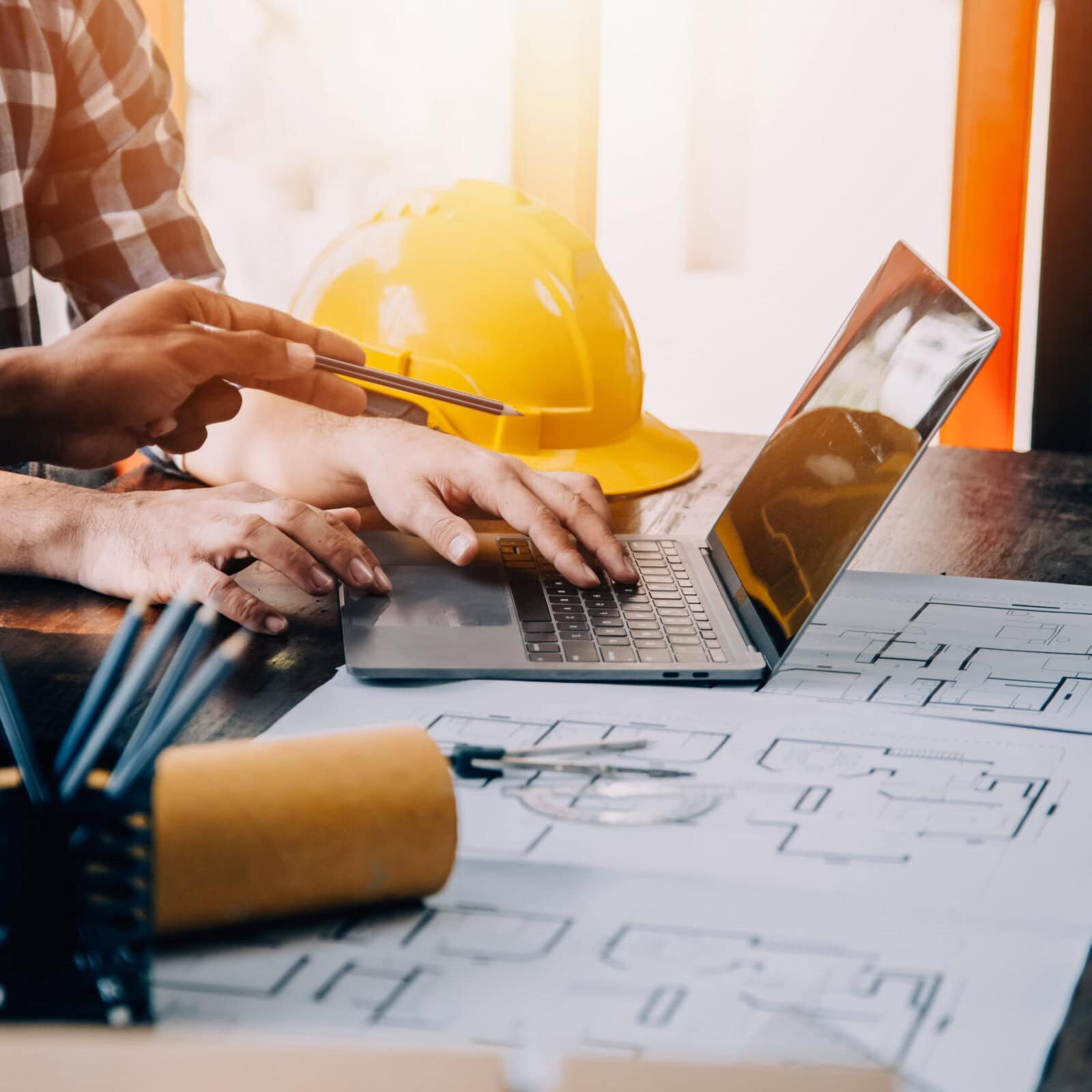 Construction and structure concept of engineer working drawing on blueprint meeting for project working with partner on model building and engineering tools in working site, construction concept.