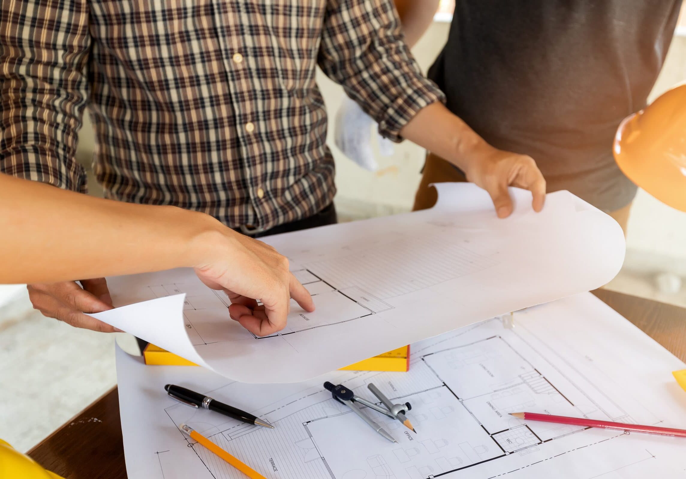 close up photo of architect's hands discussing about a project