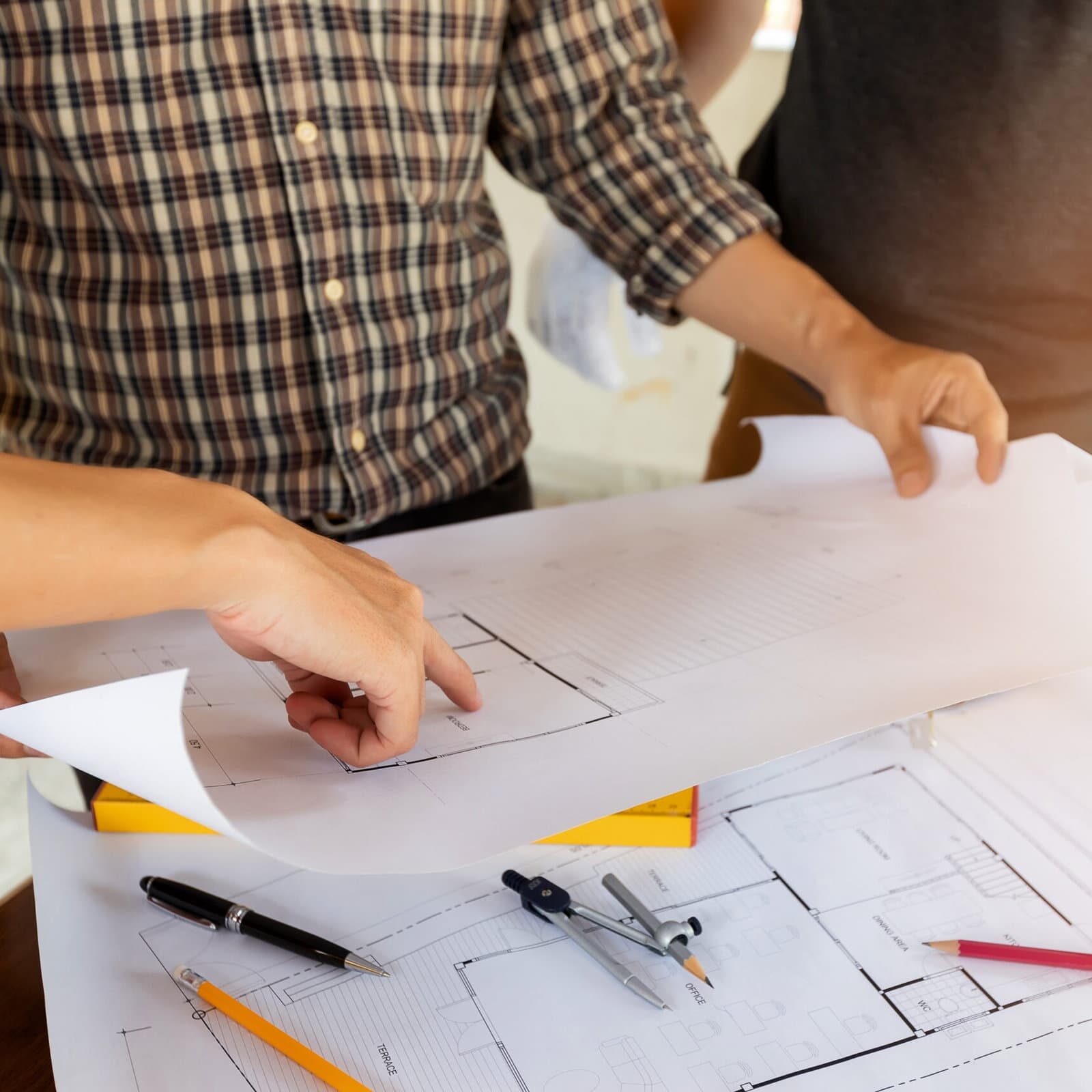 close up photo of architect's hands discussing about a project